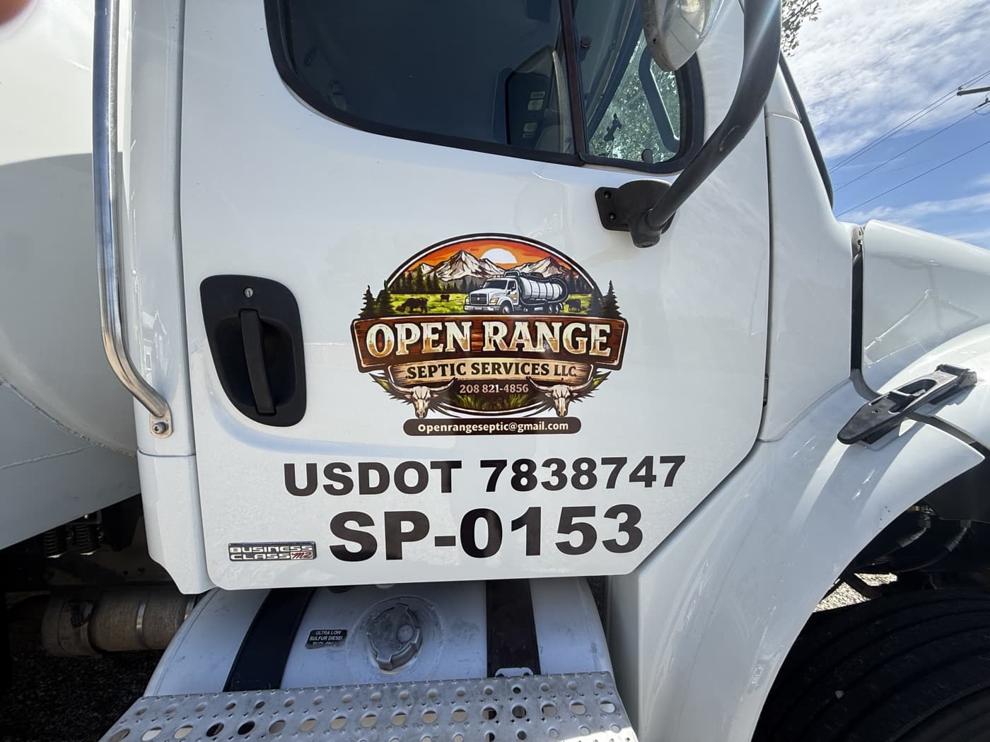 Open Range Septic Services logo on the white pump truck door.
